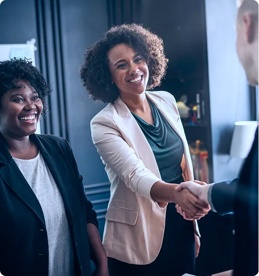 Businesswomen shaking hands at a bond issuance meeting