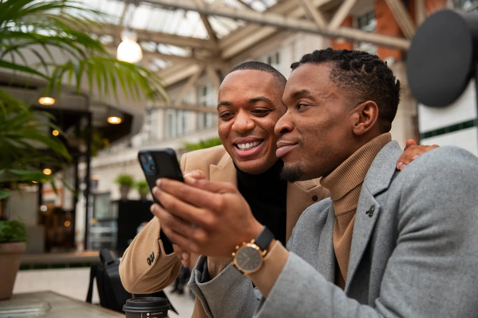 Two investors reviewing their holdings on a phone