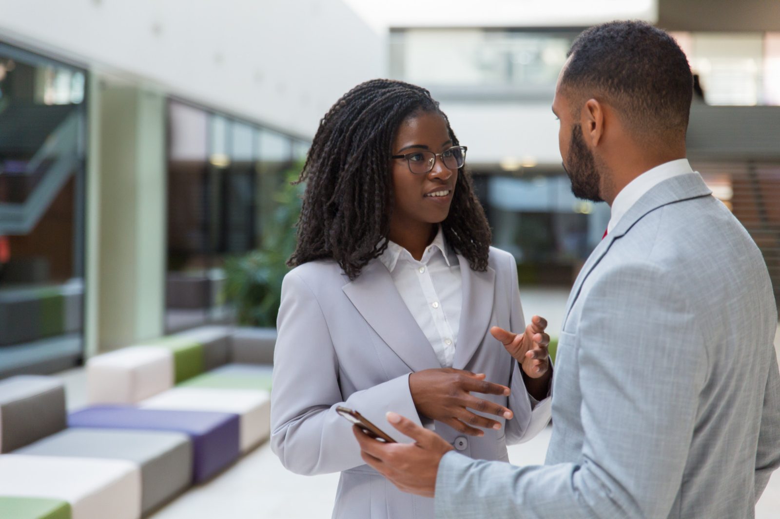 Two professionals in conversation on the NASD trading floor