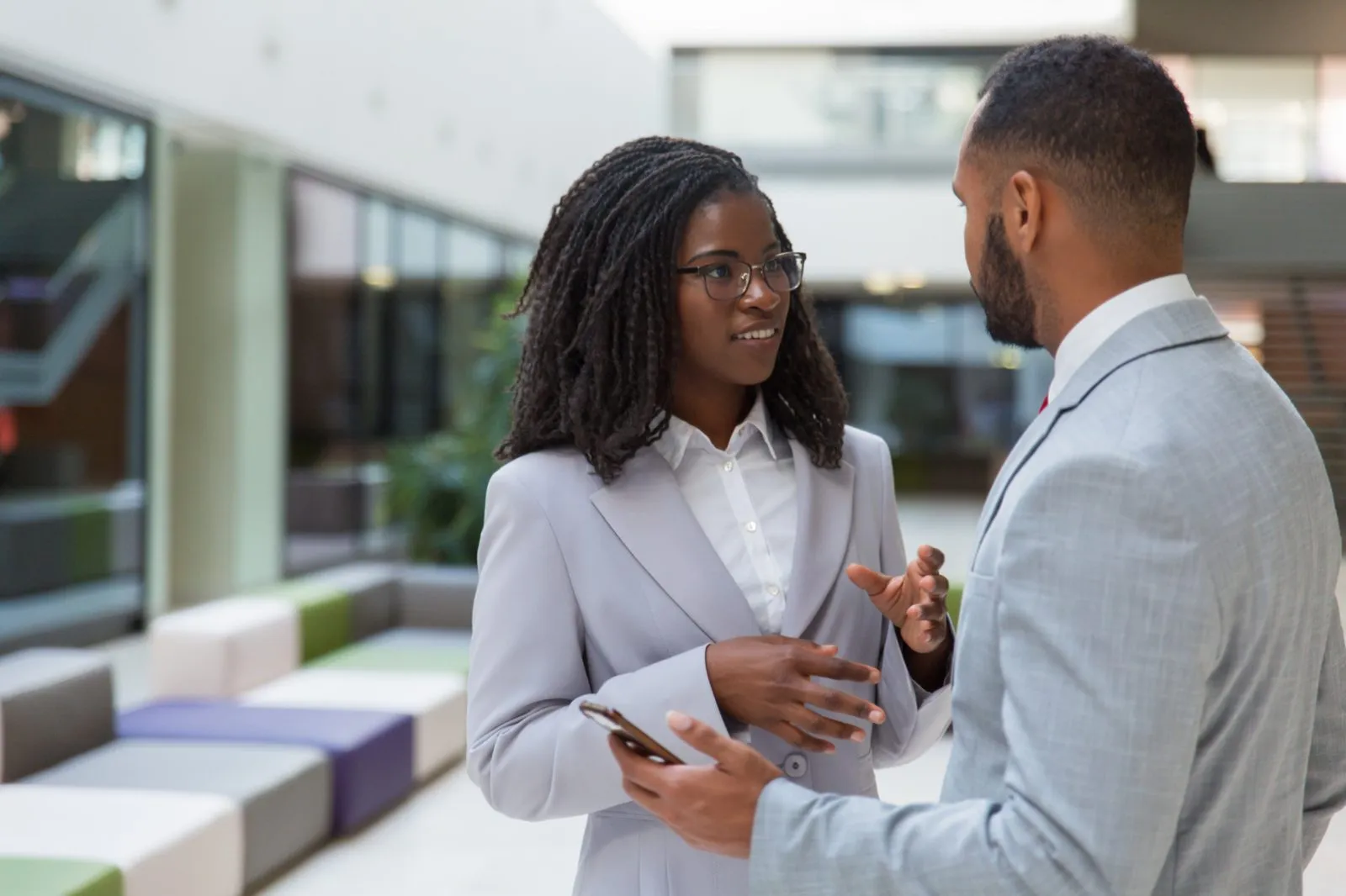 Two professionals in conversation on the NASD trading floor